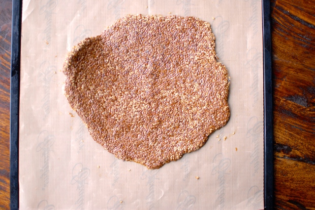 healthy sesame flax seed crackers rolled out on non-stick dehydrator mat 